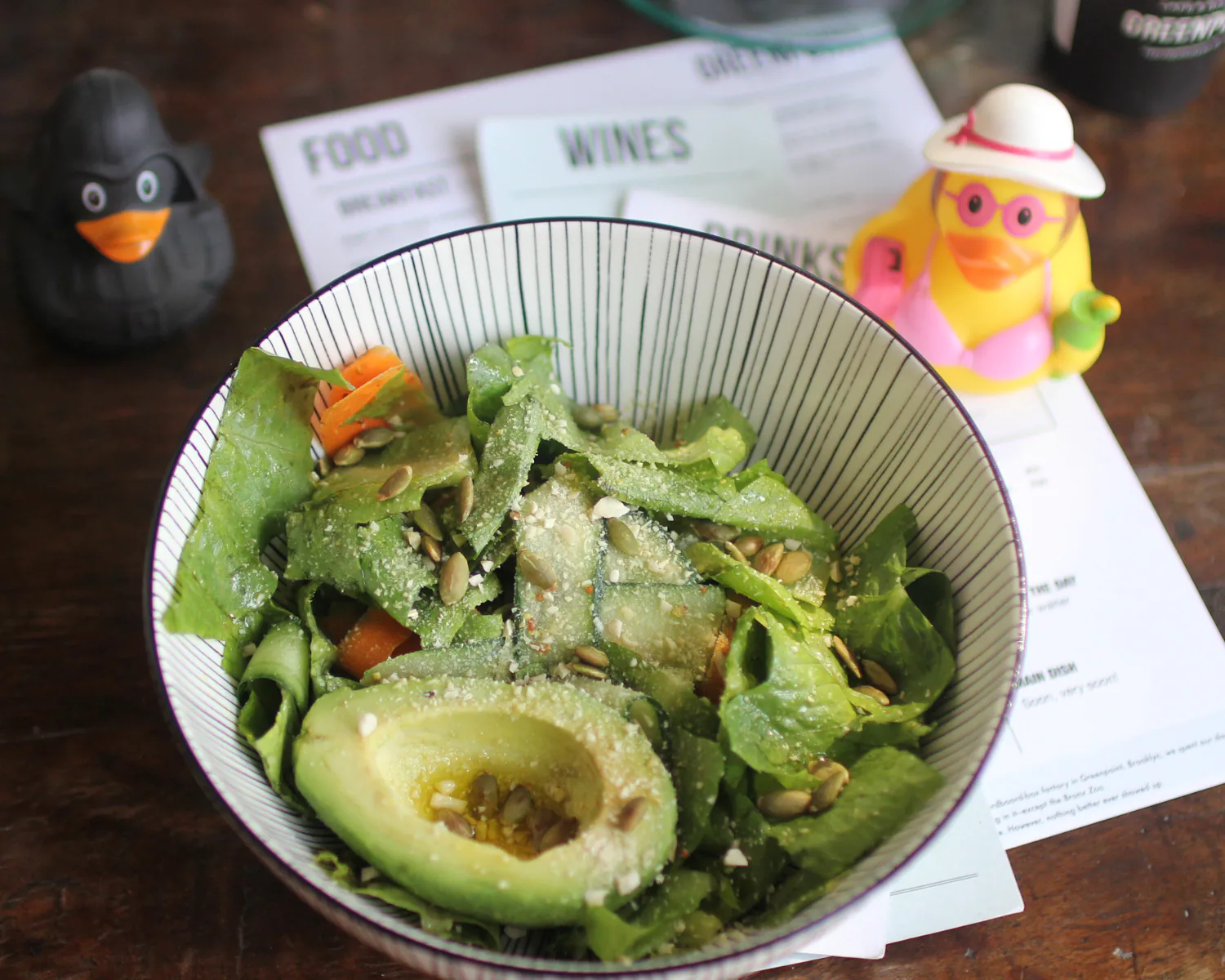 Avocado and vegetable salad with leafy greens and seeds