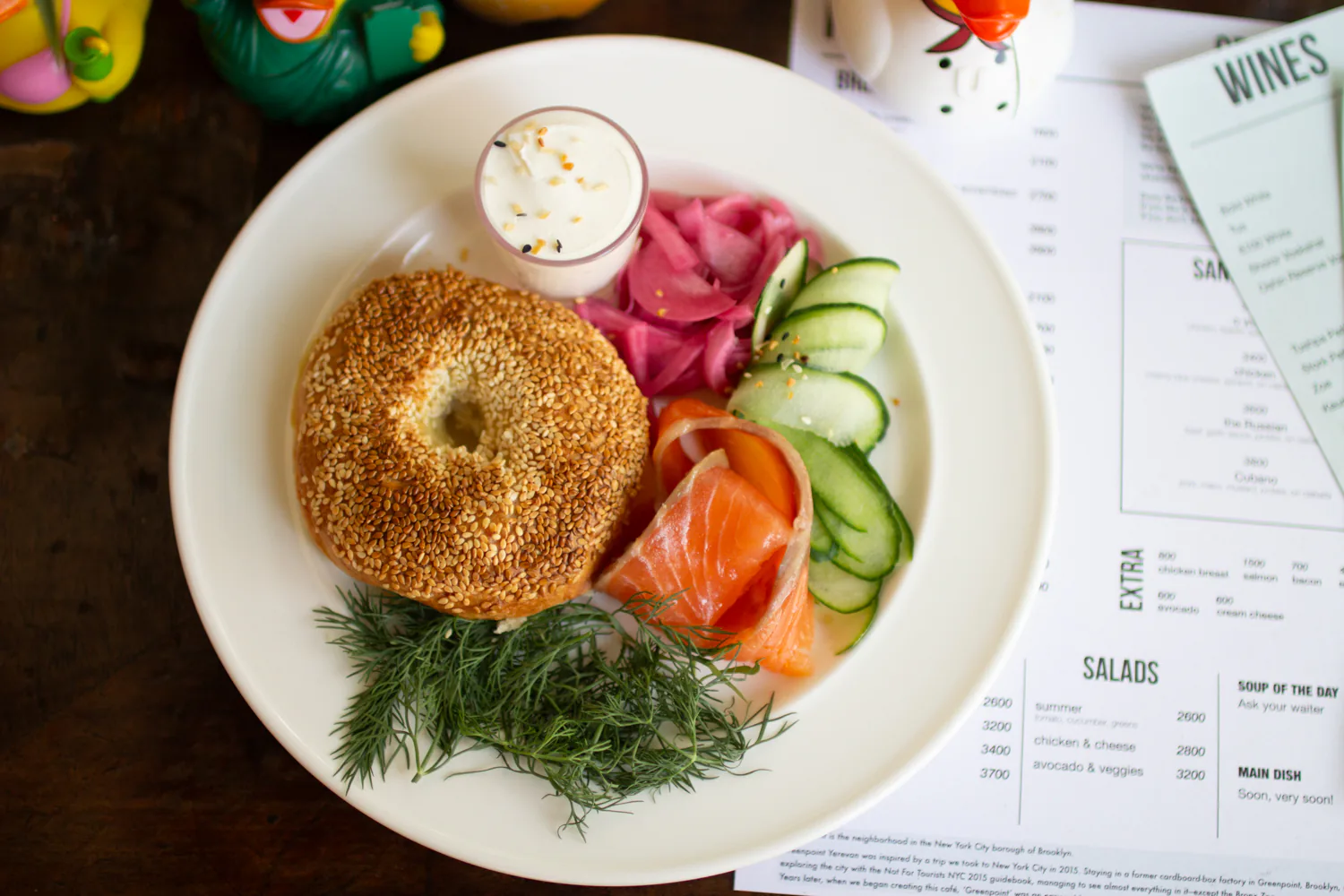 Bagel with salmon, cream cheese, cucumber, pickled onion, and dill