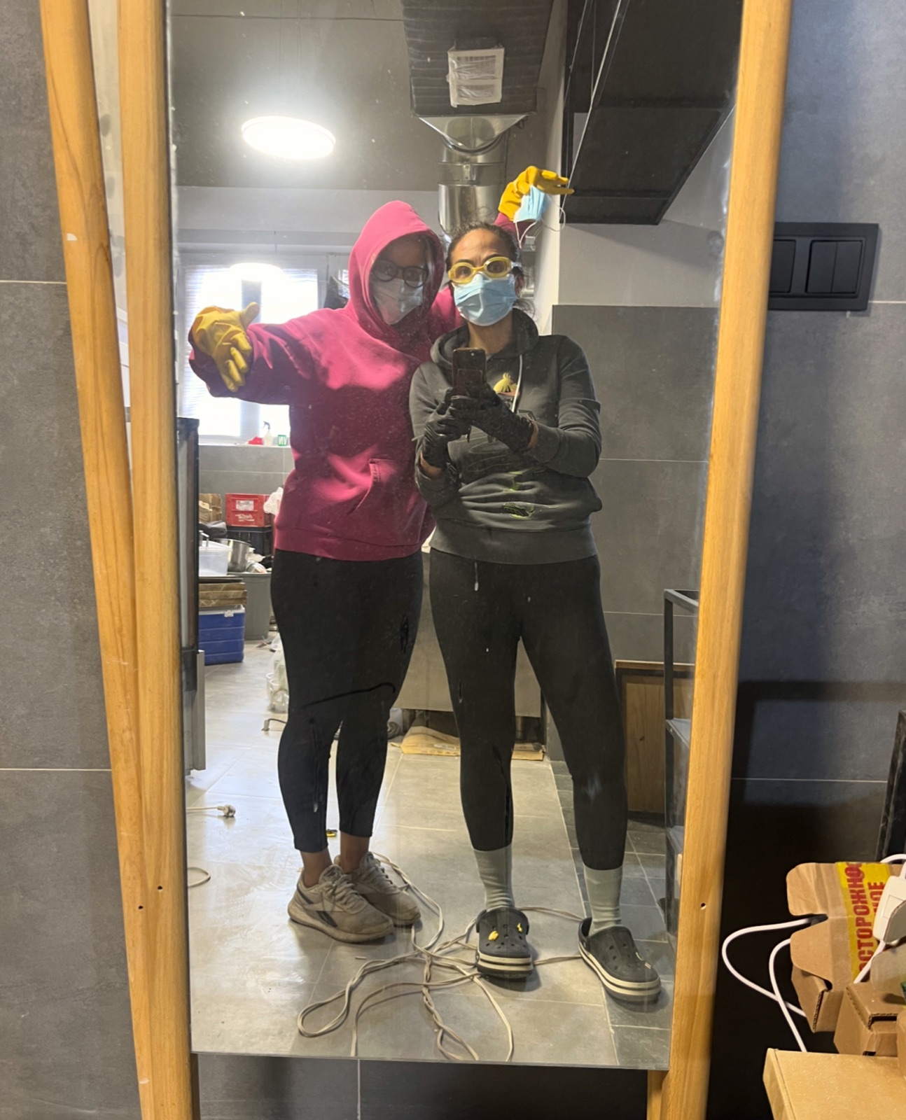 Elena and Diana Seropyan, founders and owners of Greenpoint, taking a mirror photo in the kitchen