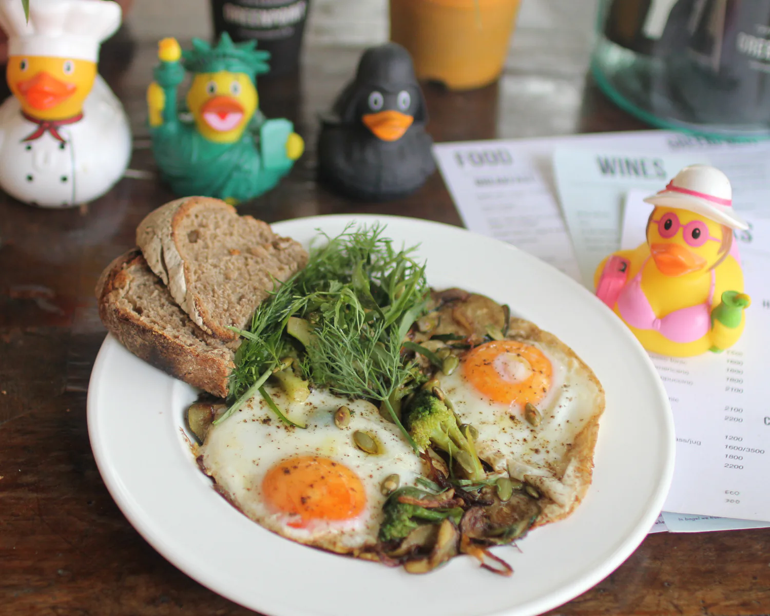 Green shakshuka with eggs, herbs, vegetables, and bread